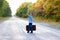 A Happy child with a suitcase on the road in the park travel