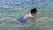 Happy Child Swimming, Splashing, Diving Underwater on the Beach in Sunlight