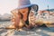 Happy child in swimsuit relaxing on the summer beach, lying on towel and playing with sand. Warm weather, cozy mood. Traveling on