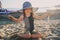 Happy child in swimsuit relaxing on the summer beach and playing with sand. Warm weather, cozy mood.