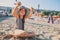 Happy child in swimsuit relaxing on the summer beach and playing with sand. Warm weather, cozy mood.