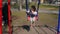 Happy Child Swinging Outdoors. Cute Girl Having Fun, Swinging Up And Down In park, Carefree Childhood