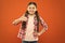 Happy child thumb up. childrens day. childhood happiness. little girl orange background. kid fashion. smiling school