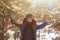 Happy child walking in a winter forest in sunny day