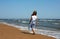 Happy child walks along the coastline ocean