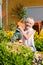 Happy child watering flowers