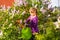 Happy child watering flowers in the garden