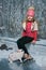 Happy child in winter putting on skates on the ice rink. rabbit running on frozen lake