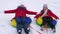 Happy childhood concept. Children`s Christmas holidays outdoors. Happy children have fun riding snow saucer and laugh on