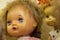 Happy childhood concept: retro toys, doll with blue eyes close-up