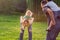 Happy Childhood - Family piggyback their children and have fun together in park