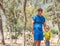 Happy Childhood Fatherhood time photo. Dad son smile laugh stand in summer day forest, look down, explore something