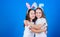 Happy childhood. Friendship concept. Easter vibes. Happy easter. Holiday bunny girls with long bunny ears hug. Children