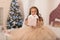 Happy childhood, magical Christmas tale. Little princess with Santa`s present for Christmas