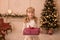 Happy childhood, magical Christmas tale. Little princess with Santa`s present for Christmas