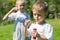 Happy children blow soap bubbles