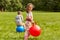 happy children bouncing on hopper balls at park