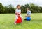 happy children bouncing on hopper balls at park