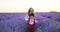 Happy children boy and girl in traditional Bulgarian folklore costumes enjoying lavender field during sunset