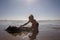 Happy children, boys, playing on the beach on sunset, kid cover in sand, smiling, laughing