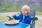 Happy children, eating spaghetti on the beach while camping on Ersfjord beach in Senja,  Norway