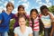 Happy children forming huddle at park