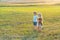 Happy children girl and boy running on meadow in summer in nature. Country life. Happy children farmers having fun on