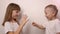 Happy children play game rock paper scissor on white background, smile and laugh