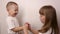 Happy children play game rock paper scissor on white background, smile and laugh