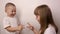 Happy children play game rock paper scissor on white background, smile and laugh