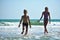 Happy children play together on the beach.