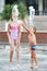 Happy children playing in a fountain