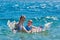 Happy Children Playing with Mattress at Sea