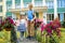 Happy children playing in the school yard at the day time.Outdoors summer walk, flowering courtyard, green park. Concept of happy