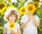 Happy children playing with sunflowers