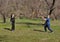 Happy children plays in frisbee outdoors keeping safety social distancing rules