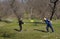 Happy children plays in frisbee outdoors keeping safety social distancing rules