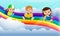 Happy children reading book over the rainbow