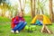 Happy children relax near the wooden bonfire, tent