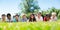 Happy children resting on grass and smiling together in park