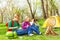 Happy children resting near the wooden bonfire