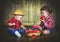 Happy children sister and baby brother with a basket of peaches