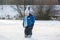 Happy children, skating on a frozen lake in the park