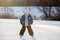 Happy children, skating on a frozen lake in the park