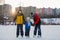 Happy children, skating on a frozen lake in the park