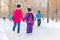 Happy children skating on the ice track in the park