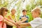 Happy children stacking hands in summer at garden