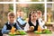 Happy children at table  healthy food in school canteen