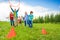 Happy children throw colorful hoops on cones