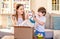 Happy children unpacking box with toys delivered by courier to house. Online shopping